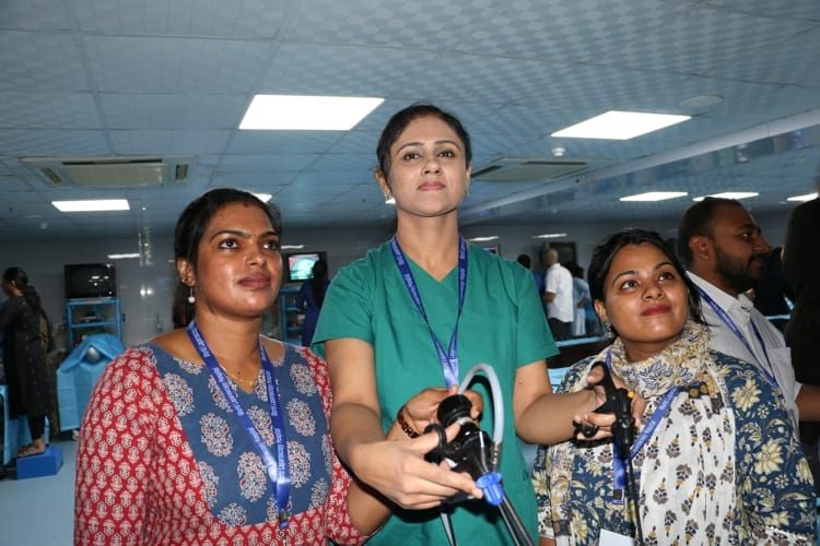 Surgeon & Gynecologist Practicing Laparoscopic Intrcorporeal Surgeons Knot Demonstration by Prof Dr. R. K. Mishra.